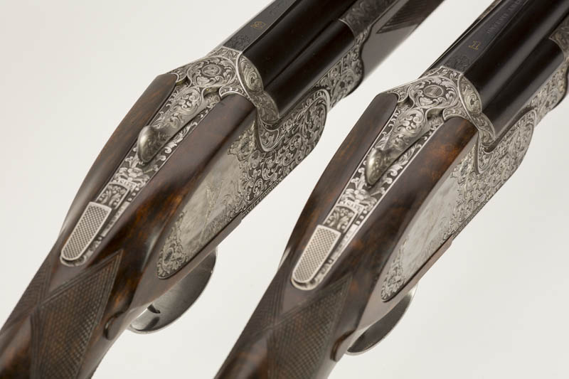 Pair of square sideplated 12 bore over and unders showing numbers